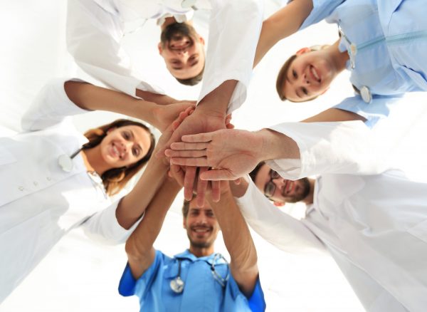 bottom view.a team of doctors at the medical center clasped their hands together.the concept of unity