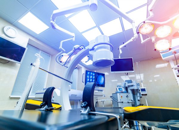 Clinic interior with operating surgery table, lamps and ultra modern devices, technology, hi-tech interior,